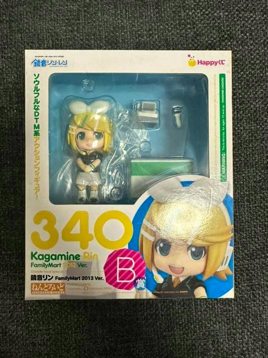 Front of the boxed Kagamine Rin FamilyMart 2013 ver. figure (No.340) showing the figure and accessories visible through the window.