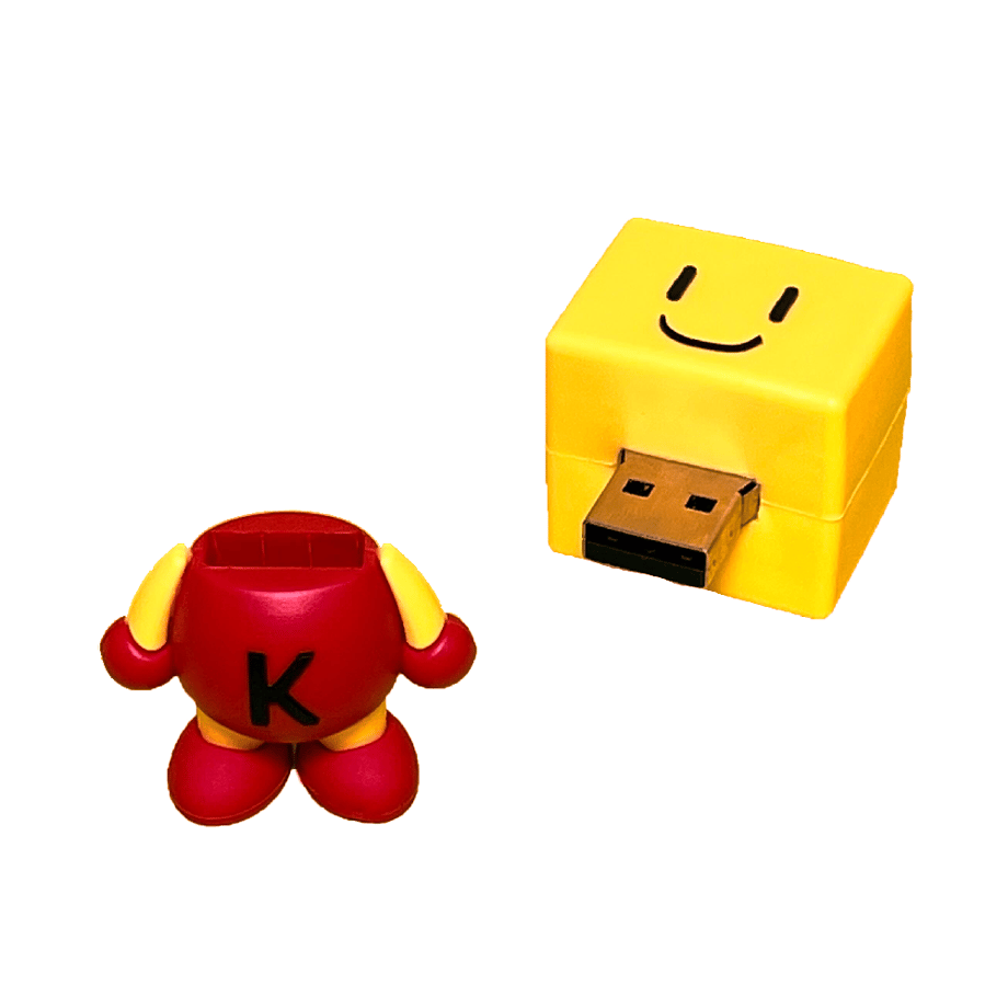 A yellow-and-red Kairo-kun USB mascot with its head cap removed, revealing the USB connector.