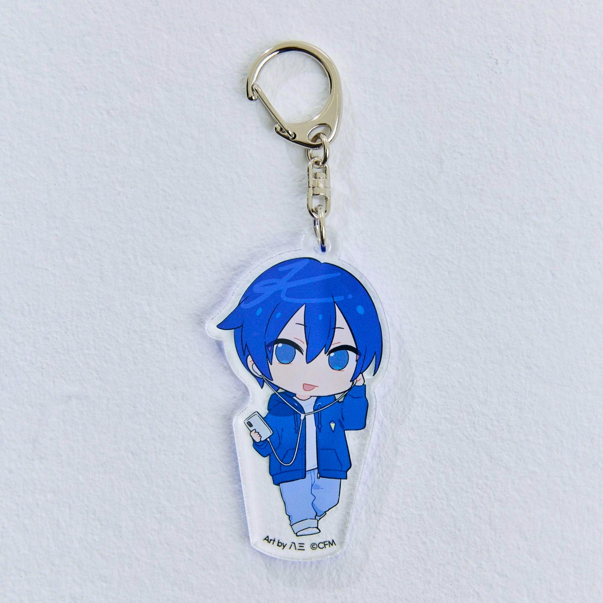 Photo of the KAITO acrylic keychain showing its metal key ring and the top portion of the blue-haired acrylic charm on a white textured background.