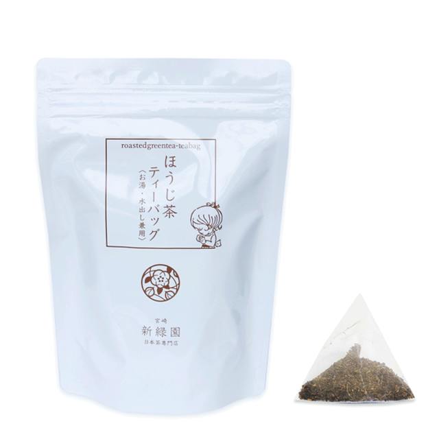 White resealable pouch of hojicha (roasted green tea) with a pyramid teabag of loose leaves beside it.