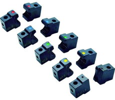 Multiple small black replacement cutter blade blocks with colored dots arranged together.