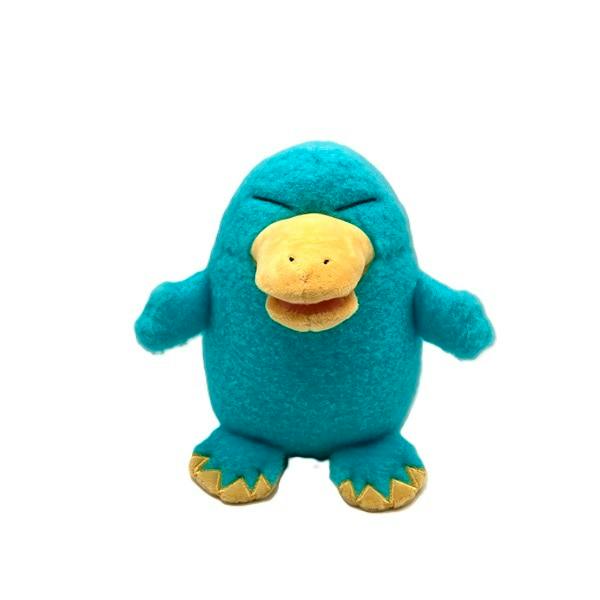 Front view of the カモノハシのイコちゃん わたがしぬいぐるみ plush toy showing its teal body with a yellow beak and feet.