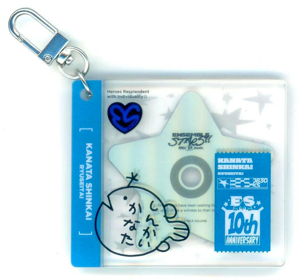 A rectangular acrylic keychain showing a star-shaped CD motif, a blue side tab reading "KANATA SHINKAI", a simple fish doodle, and a metal clasp.