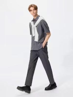 Male model wearing the men's polyester pants shown full-length while walking.