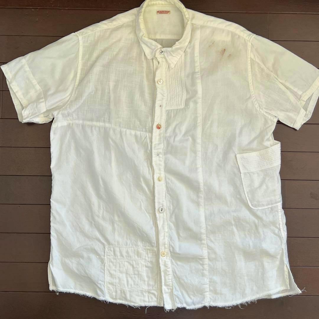 White linen patchwork KAPITAL/KOUNTRY Kathmandu men's shirt laid flat showing the front, buttons, and pocket.