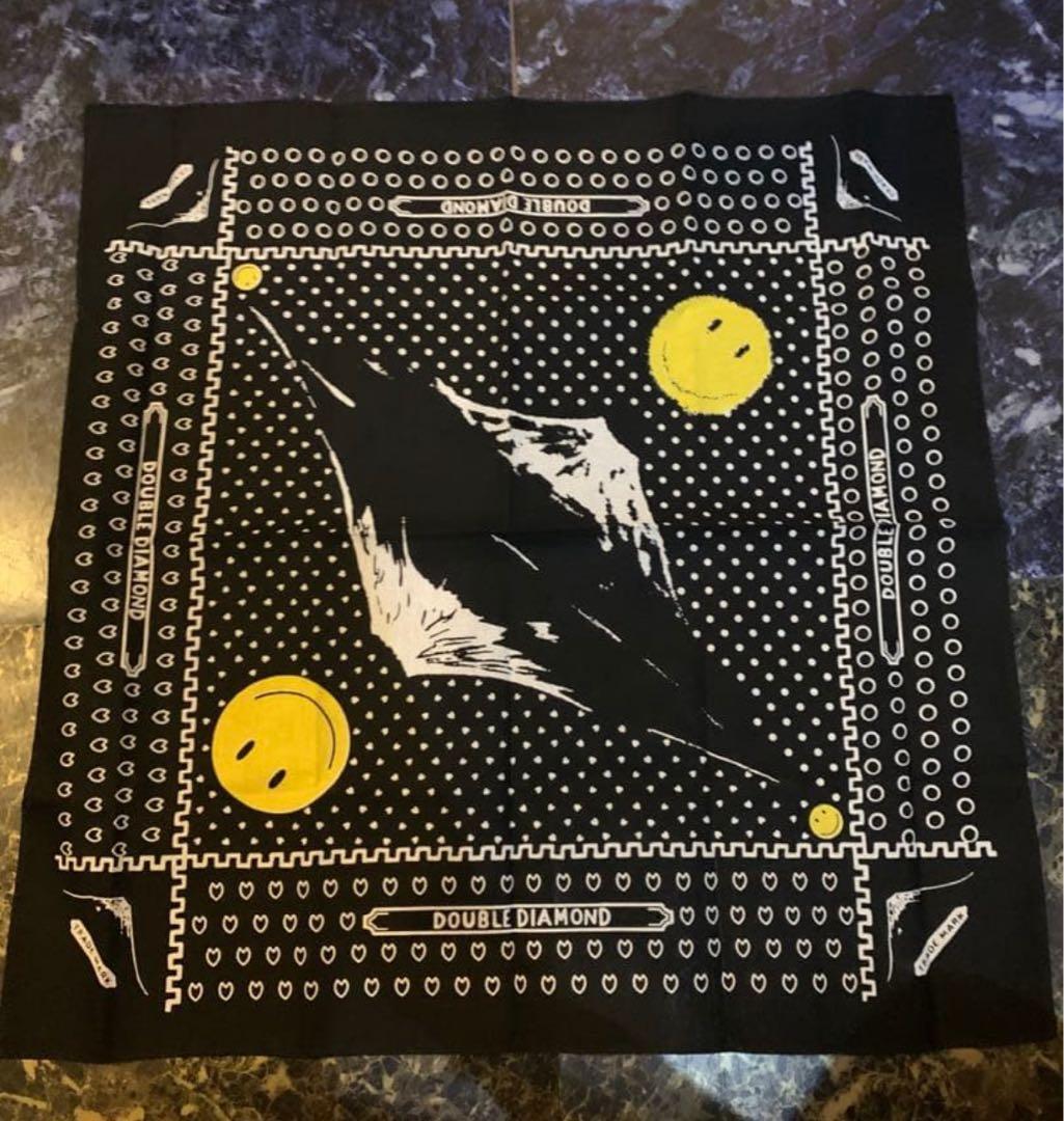 Black bandana laid flat showing a white mountain motif, yellow smiley faces, and white dot-and-heart border.
