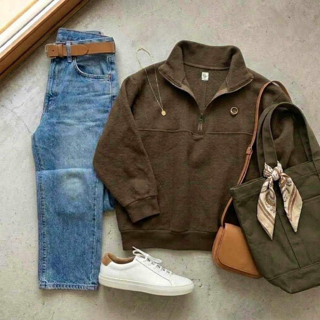 Brown cotton-blend wool driver’s knit sweater laid flat in a styled outfit with jeans, white sneakers, and a tote bag.