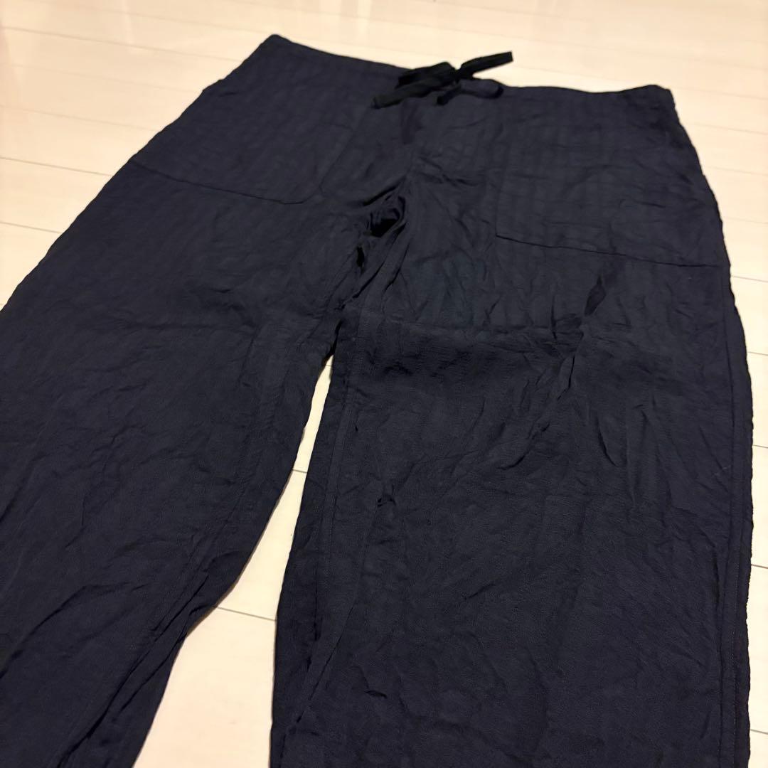 Navy linen women's easy pants laid flat showing front with drawstring and patch pockets.