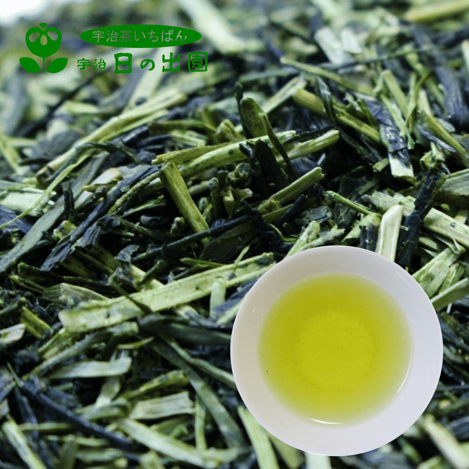 Close-up of loose-leaf green tea with a white cup of brewed green tea placed on top.