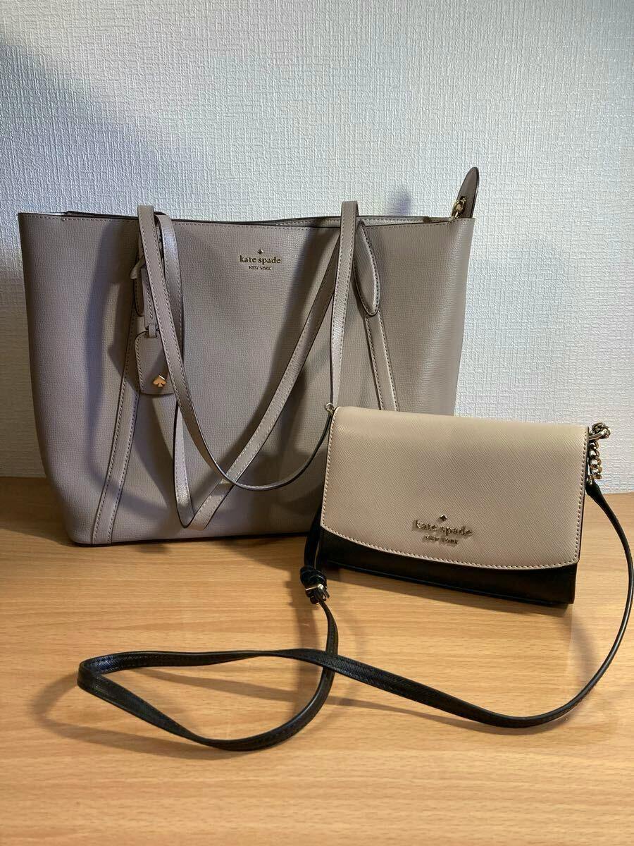 A kate spade tote bag and a smaller crossbody/shoulder bag displayed on a wooden surface.