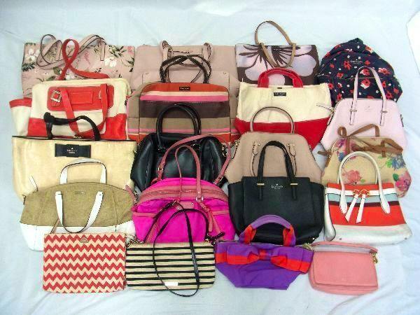 A spread of multiple Kate Spade handbags, tote bags, and shoulder bags arranged together on a white background.