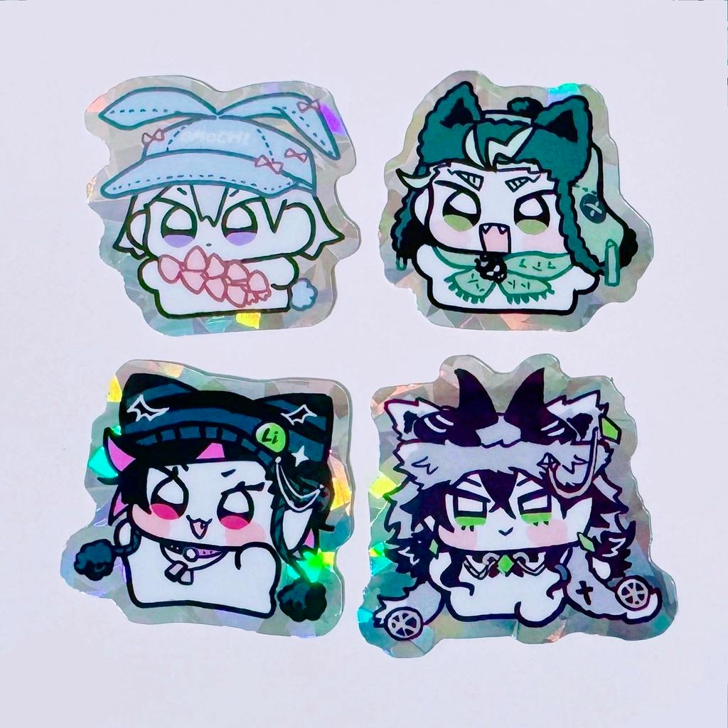 Four holographic paper stickers showing stylized character faces on a white background.