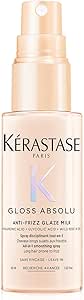 Front view of a small pump spray bottle labeled Kérastase Gloss Absolu hair milk.