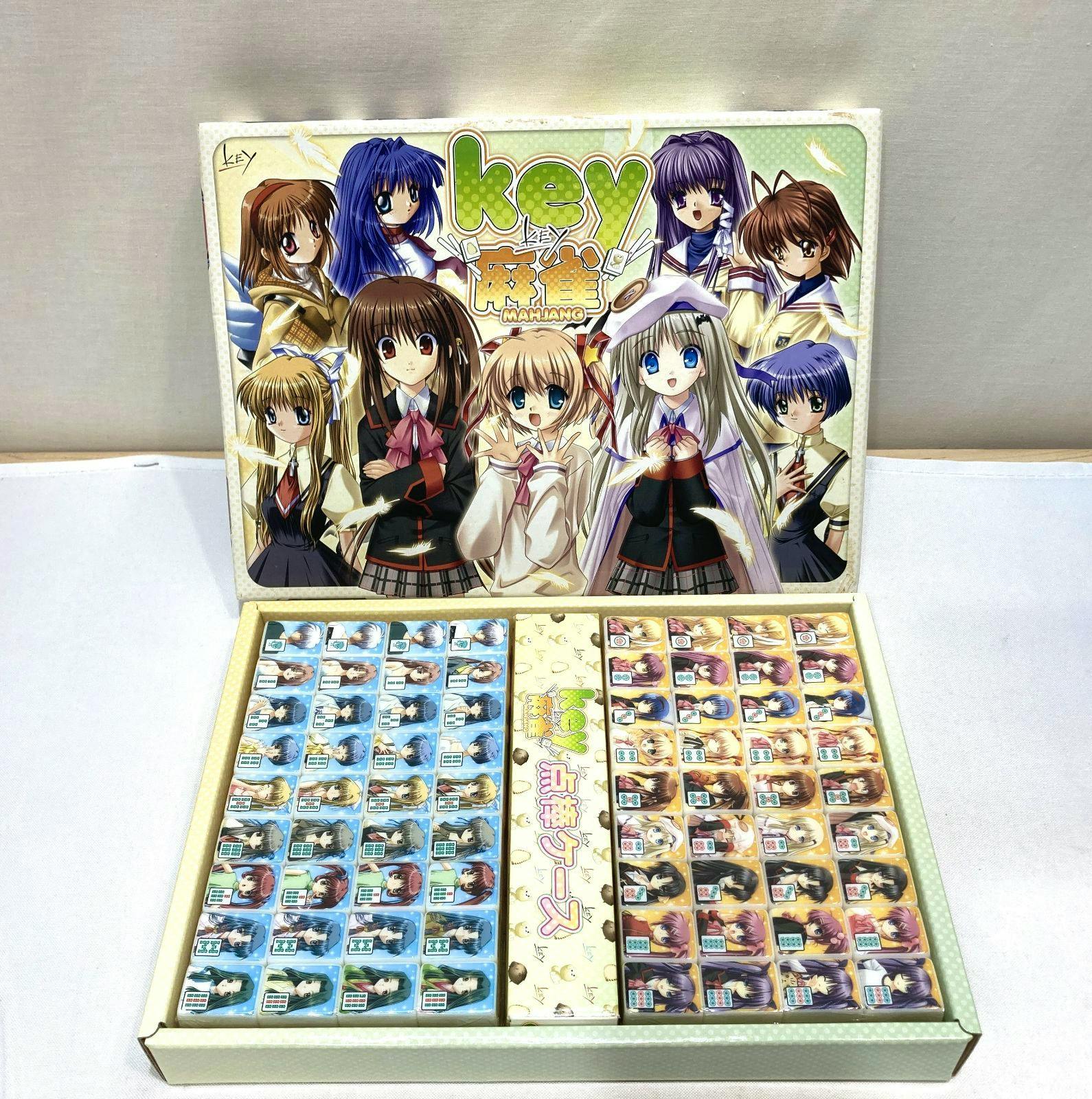 Open boxed Key Little Busters mahjong set showing character-printed mahjong tiles and the illustrated box cover.