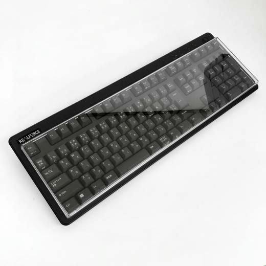 A transparent plastic keyboard cover placed over a full-size keyboard.