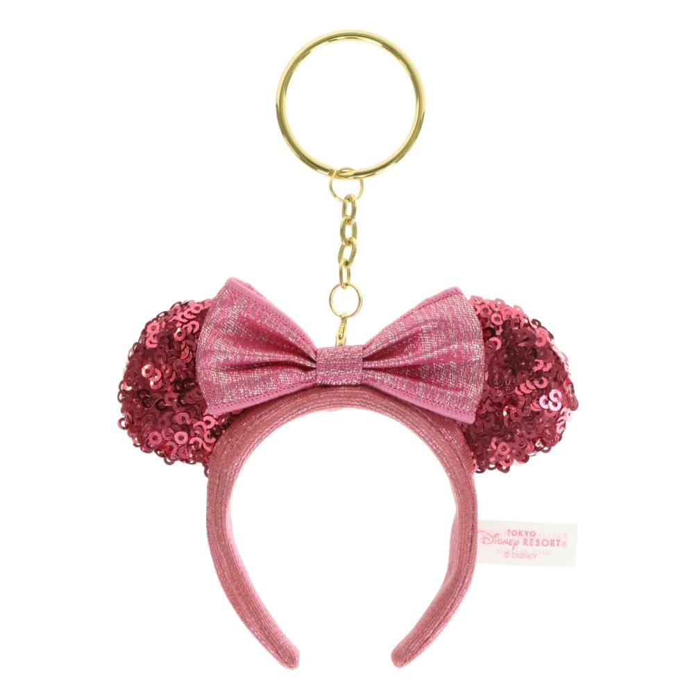 Pink sequined ears headband keychain with a pink bow attached to a gold key ring.