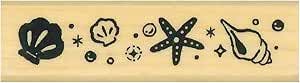 Wooden stamp block showing a row of shell and starfish stamp designs across its surface.