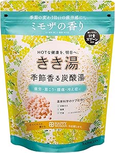 Front view of the Kikiyu Seasonal Carbonated Hot Water bath salt resealable pouch showing Japanese labeling and a green-yellow floral design indicating mimosa scent.