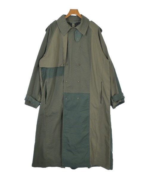 Green men's polyester coat with patchwork panels hanging on a wooden hanger against a white background.