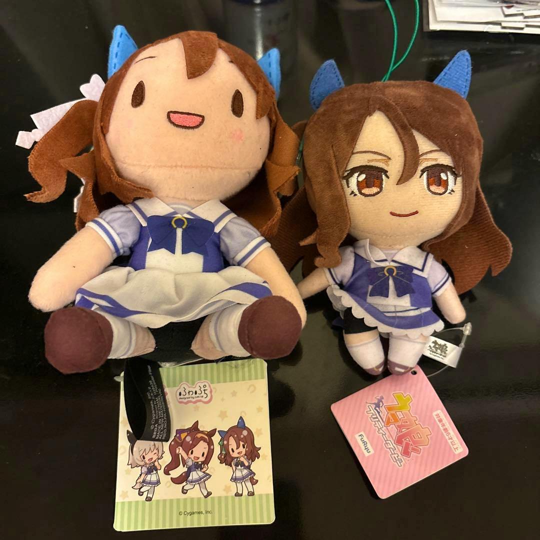 Two King Halo plush toys in blue-and-white outfits photographed side by side with attached tags.