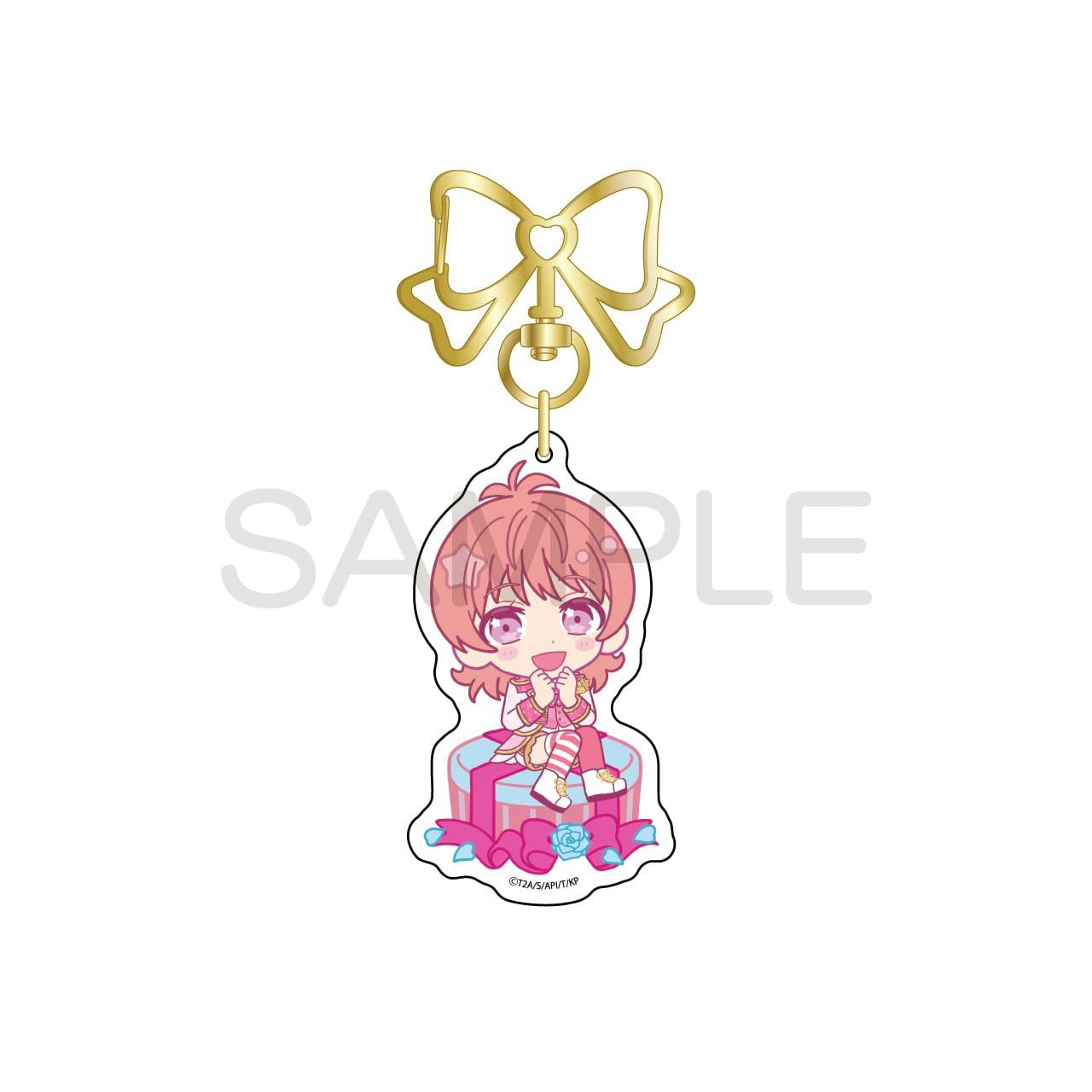 A KING OF PRISM acrylic keychain showing a chibi illustration of Saionji Leo attached to a decorative gold bow clasp.