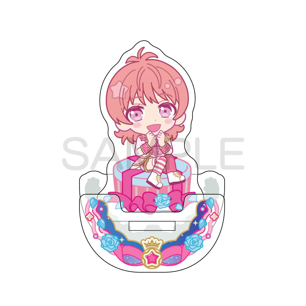 Assembled chibi acrylic stand of the KING OF PRISM character 西園寺レオ sitting on a round gift with a decorative base on a white background.