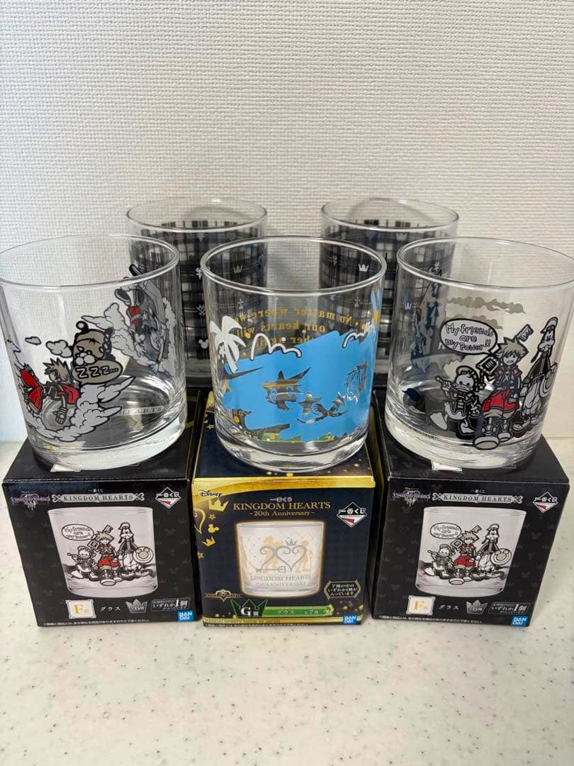 Five Kingdom Hearts branded drinking glasses with printed designs displayed on their boxes.
