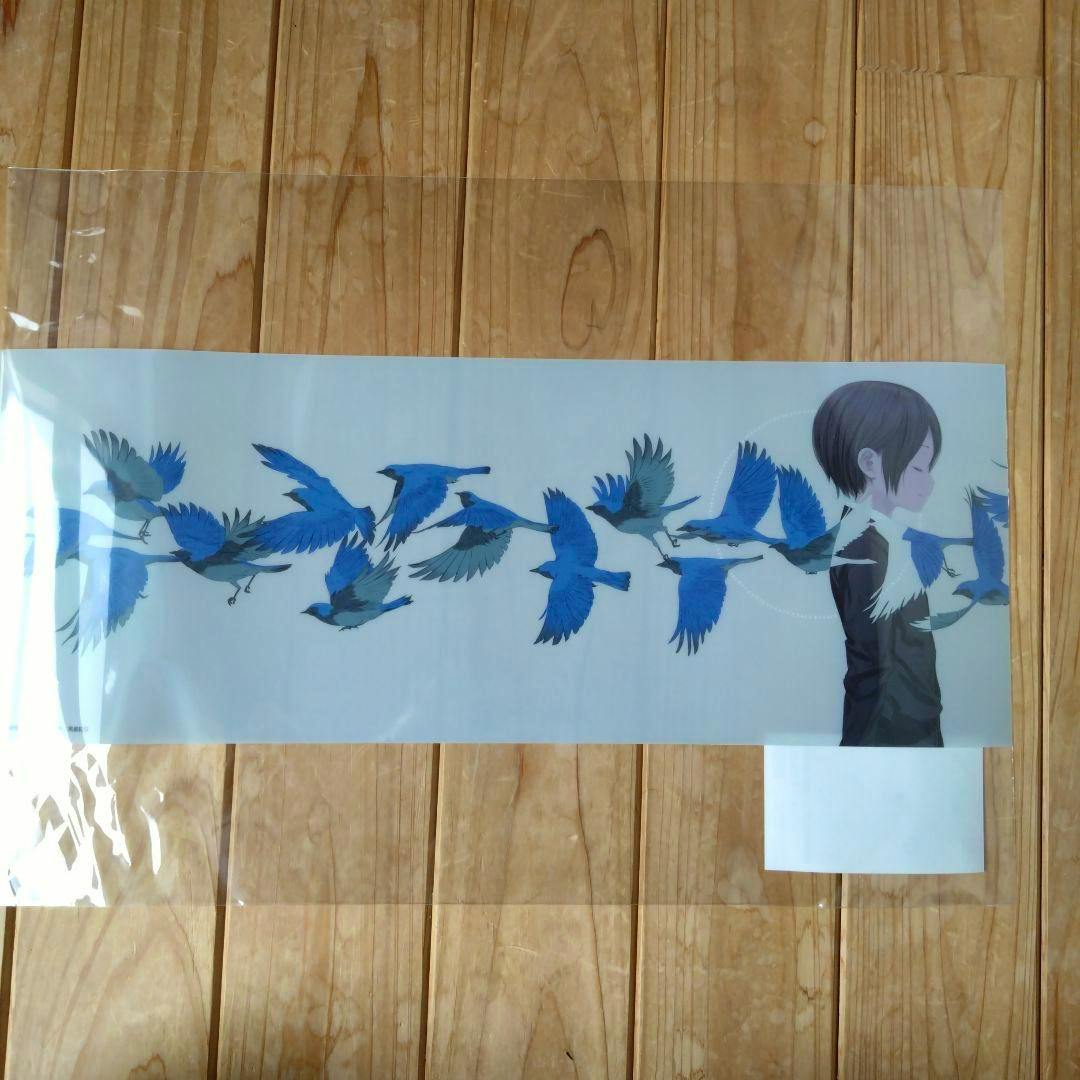 Kino's Journey clear poster showing a side-profile character and a row of blue birds, photographed in its plastic sleeve on a wooden floor.