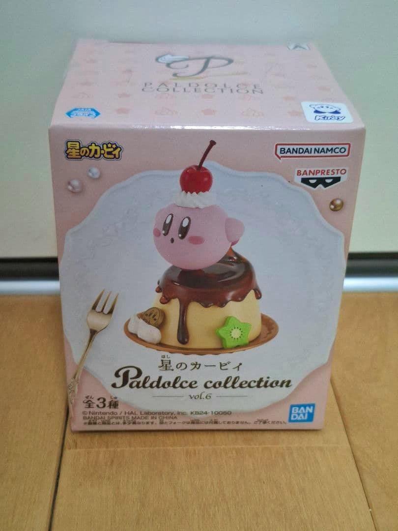 Front photo of the Paldolce collection Kirby pudding figure box showing artwork of Kirby sitting on a pudding with a cherry and brand logos.