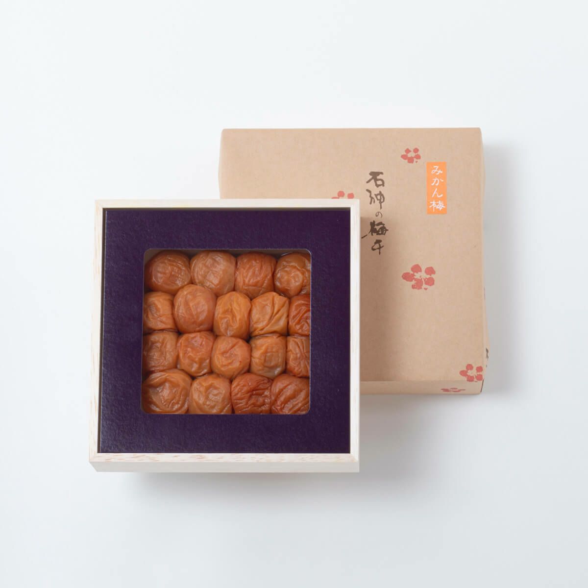 Wooden box of preserved plums (Kishu Nanko ume, mikan ume) with the cardboard lid shown behind it.