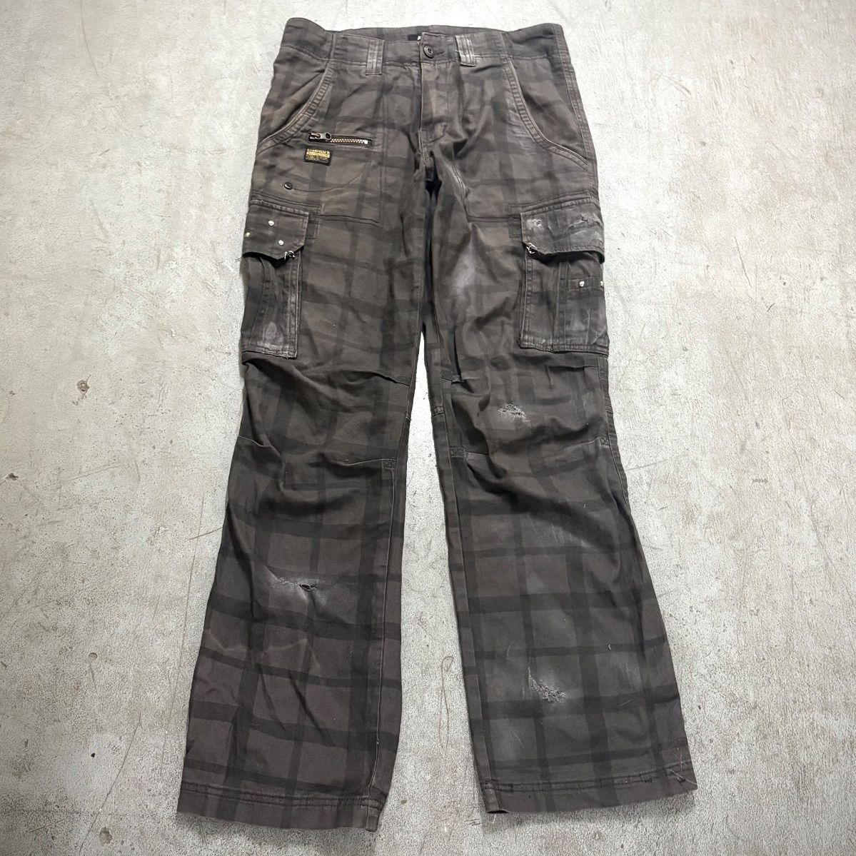 Flat-lay of women's cotton cargo pants with a check pattern and cargo pockets.