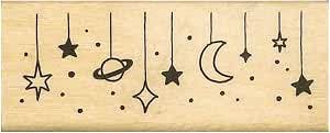 Wooden planner stamp showing a row of hanging space-themed icons including stars, a planet, and a crescent moon.
