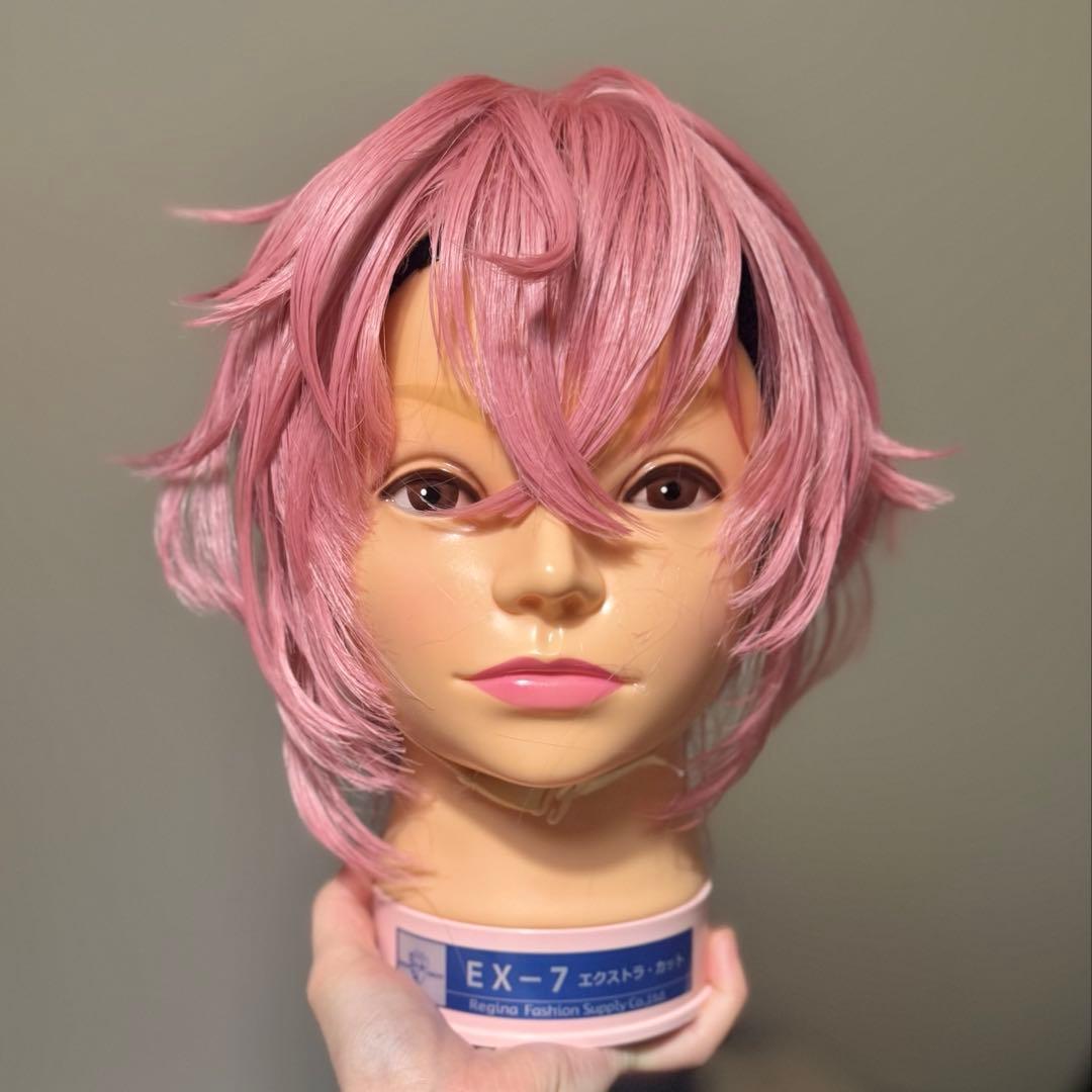 Front view of a short pink synthetic wig styled on a mannequin head.