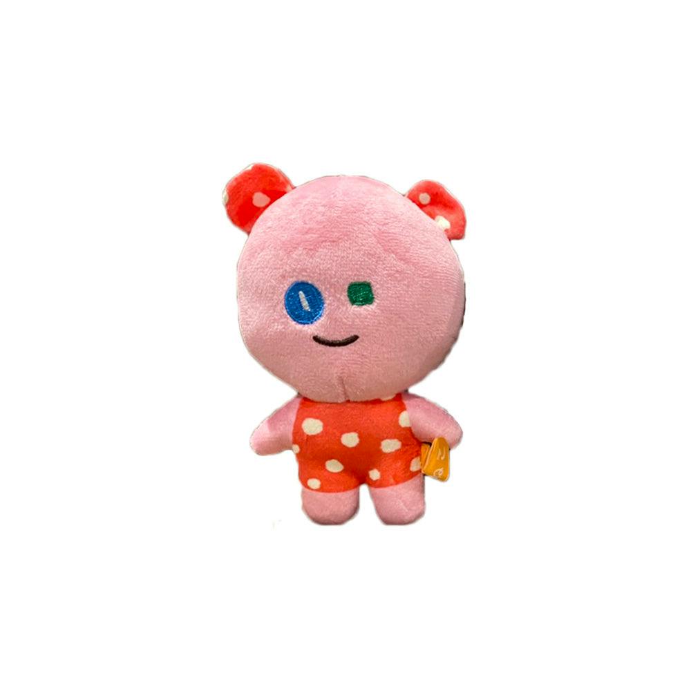 Front view of the pink こまねこ-series plush mascot wearing an orange polka-dot outfit on a white background.
