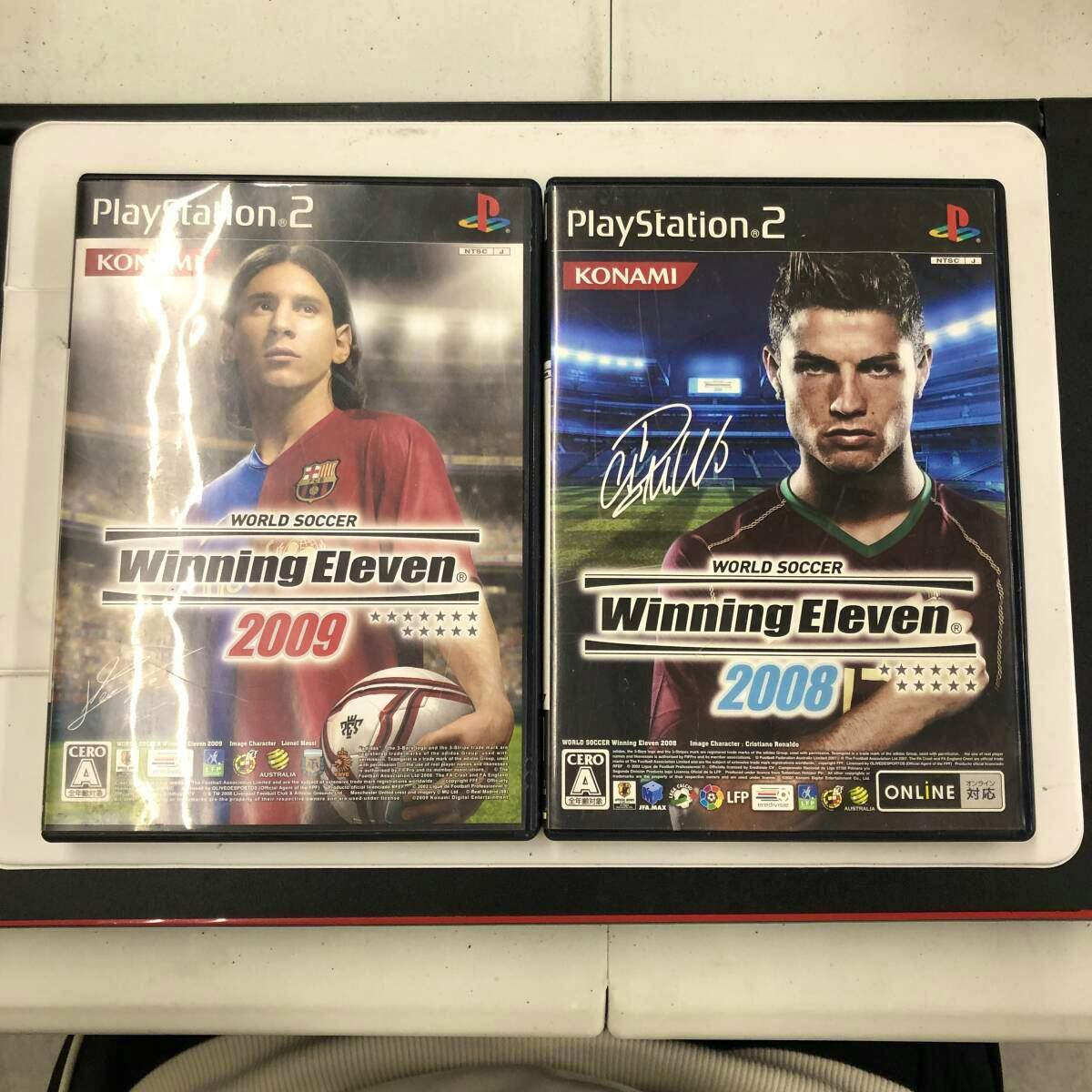 Two PlayStation 2 game cases of Winning Eleven (World Soccer) 2009 and 2008 shown side by side.