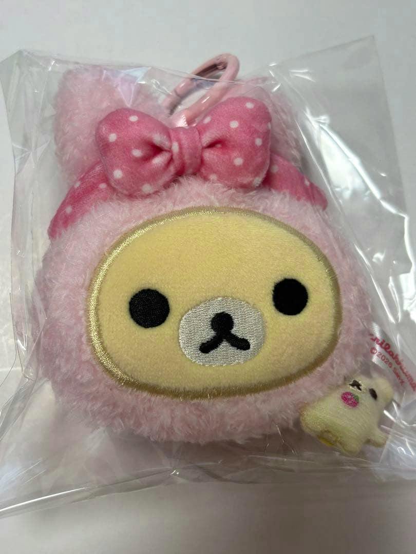 Front view of a pink Korilakkuma rabbit POPUP plush measuring tape inside clear plastic packaging.