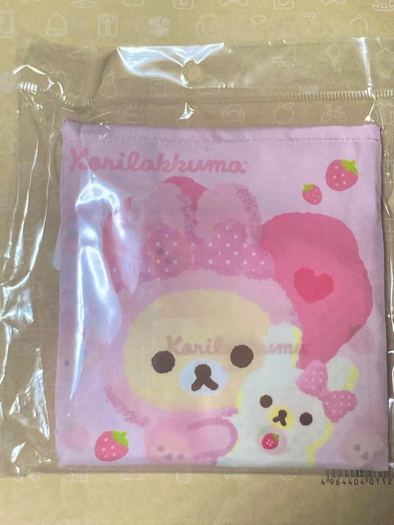 Folded pink Korilakkuma rabbit eco bag in clear plastic packaging showing the character and strawberries.