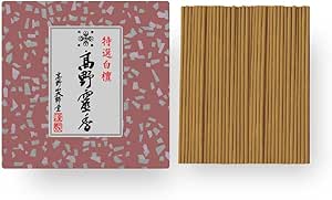 A pink patterned box of Koyasan sandalwood incense displayed next to a bundle of short brown incense sticks.