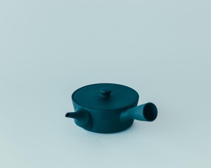 A dark-colored porcelain kyusu teapot shown on a plain background.