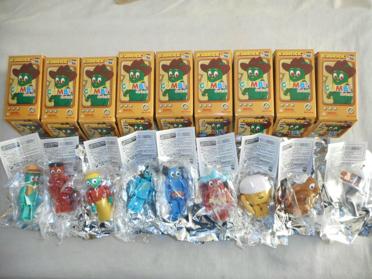 Nine KUBRICK Gumby Series 2 boxed figures with the nine individual figures shown in their sealed plastic and foil packaging arranged in front.