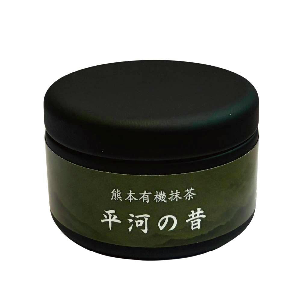 A black round tin container with a green label showing Japanese text reading “熊本有機抹茶 平河の昔”.