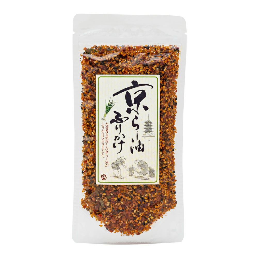 Clear pouch of Kyō rāyu furikake (chili-oil rice seasoning) showing the seasoning granules and front label.
