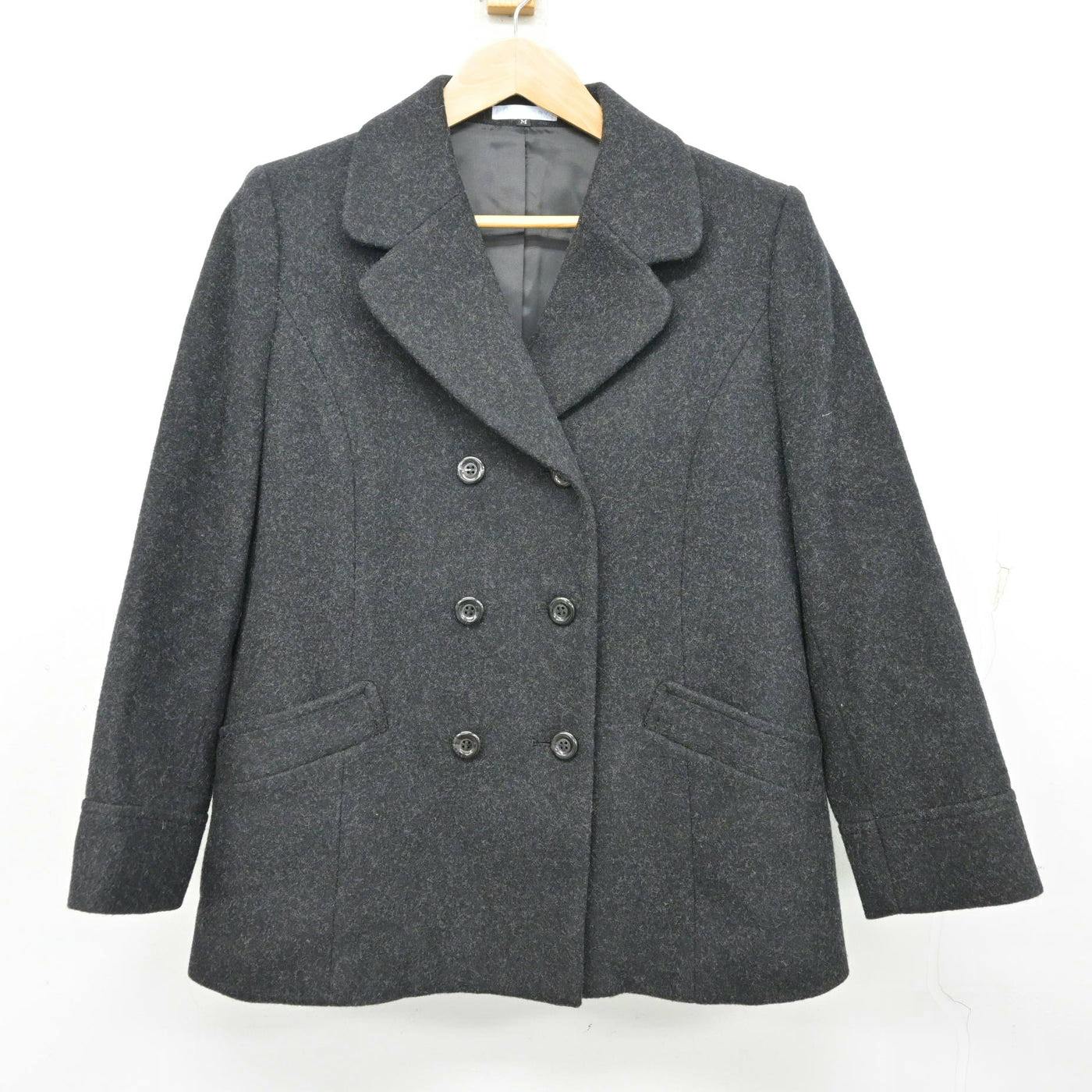 Front view of a dark gray wool women's school uniform coat hanging on a hanger.