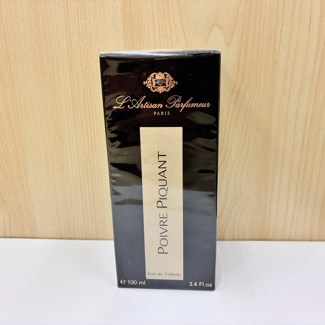 Front view of the boxed L'Artisan Parfumeur "Poivre Piquant" 100 ml perfume in black packaging.