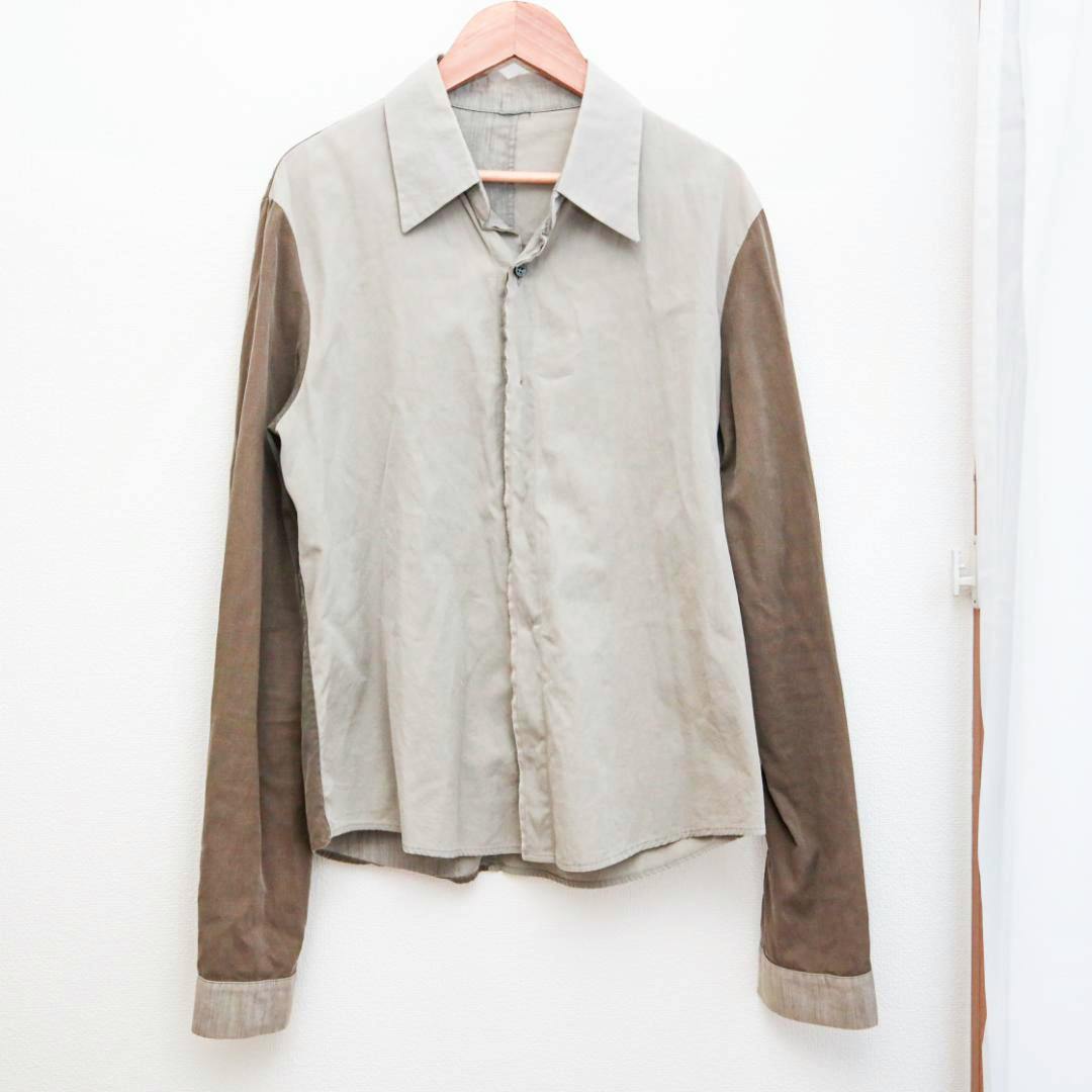 Front view of the men's cotton shirt hanging on a wooden hanger showing the full front and long contrasting sleeves.