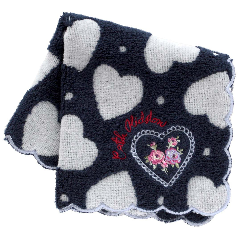 Folded dark navy cotton handkerchief with white heart pattern, scalloped edge, and a small embroidered floral heart motif.