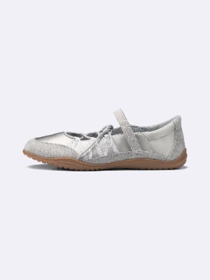 Side view of a silver lace-up ballet sneaker with a strap and rubber sole.
