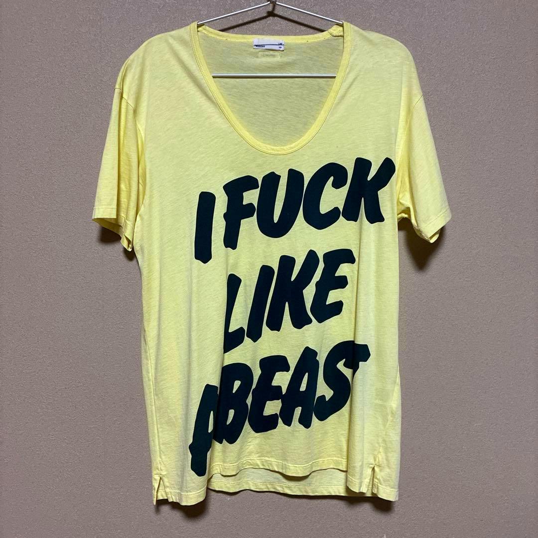 Yellow T‑shirt hanging on a hanger with large bold black printed text across the front.