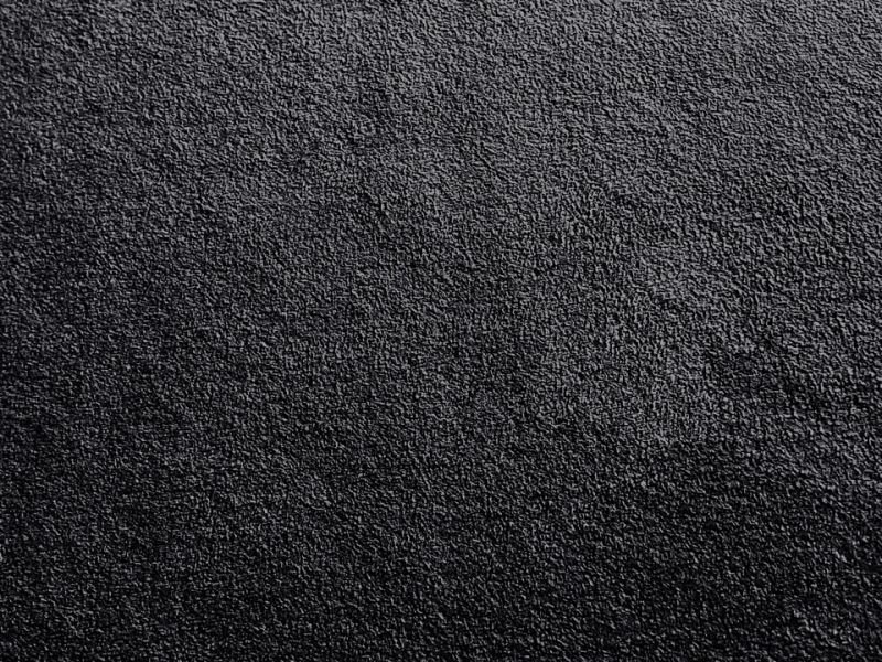 Close-up of black synthetic micro-suede fabric texture.