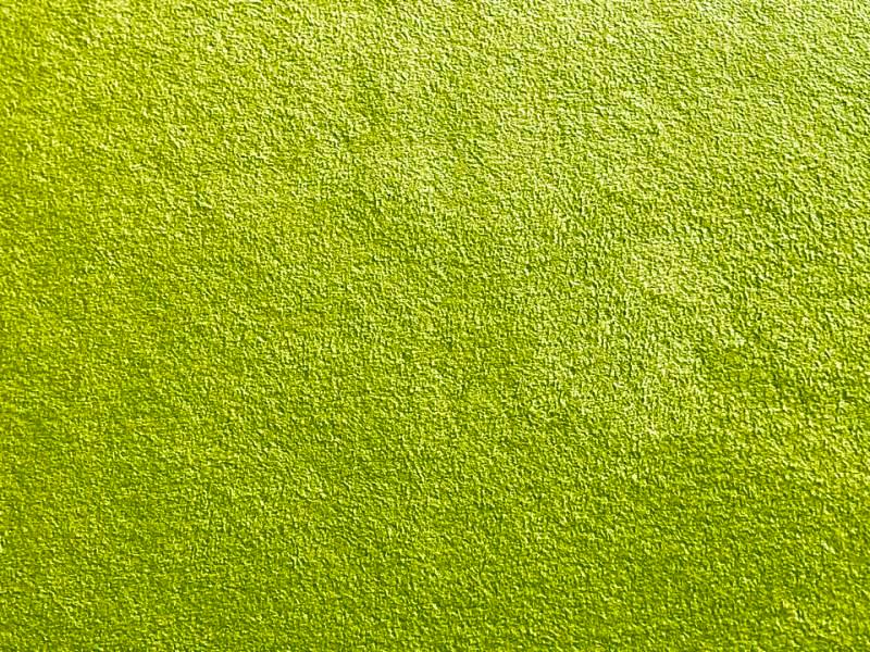 Close-up photo of lime-green suede-like polyester fabric showing its textured surface.